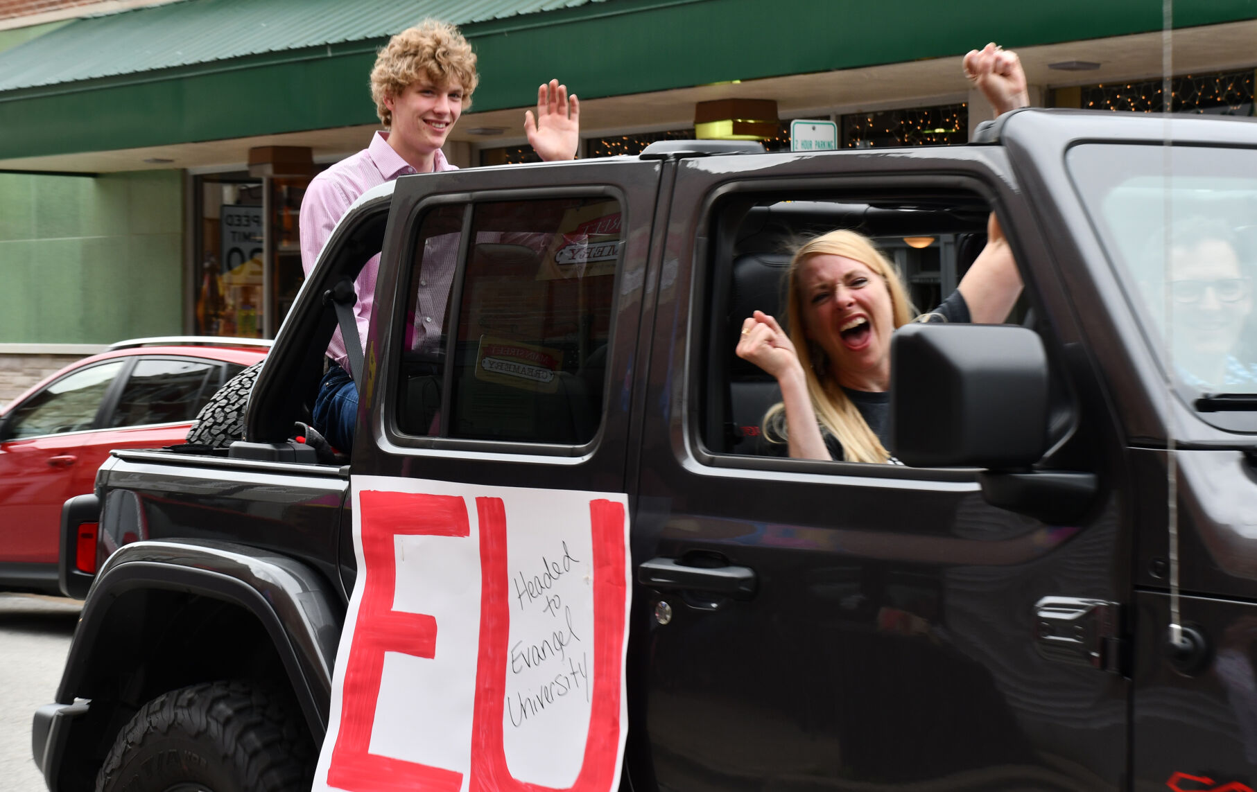 Ben Scheperle waves during parade